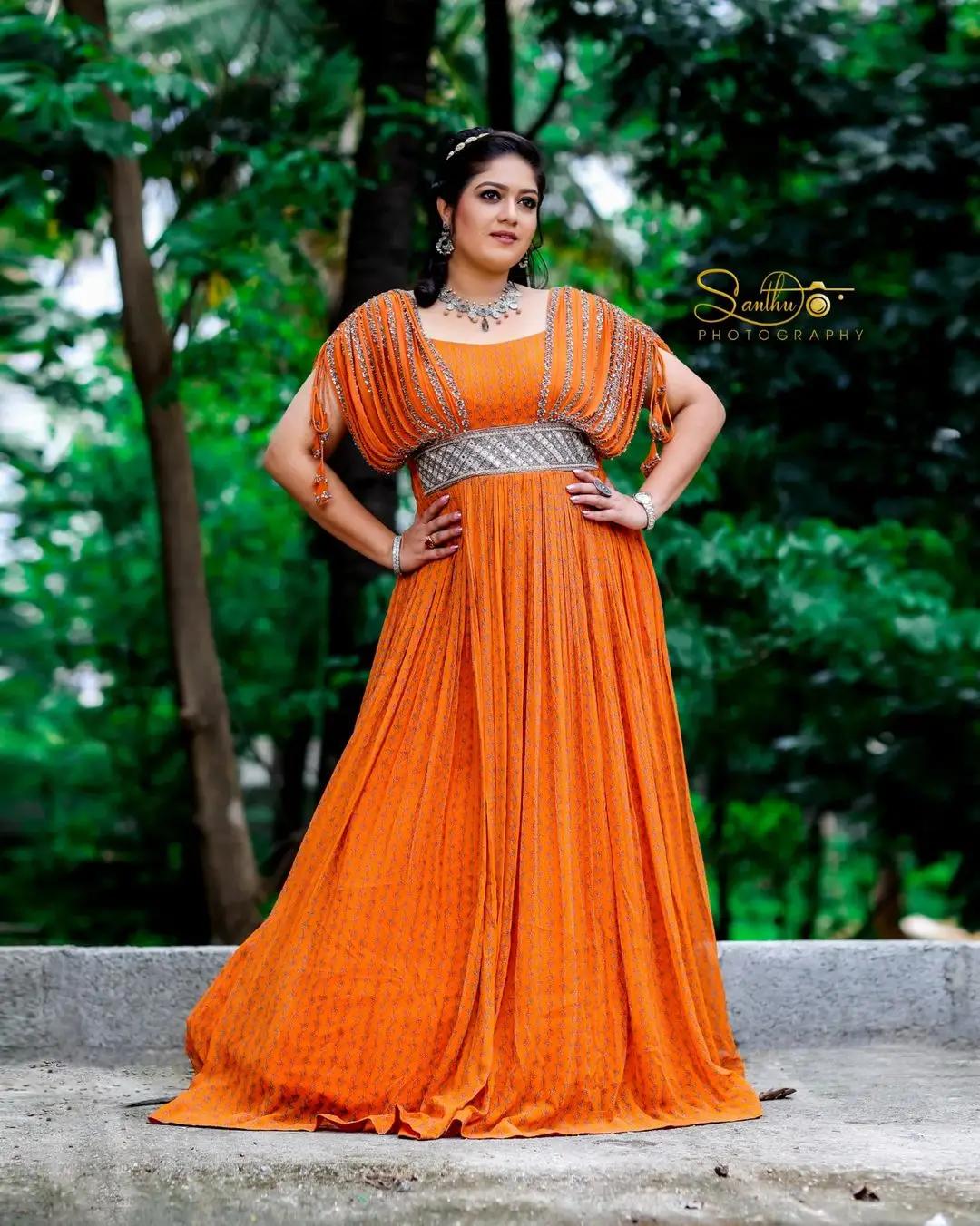 Meghana Raj Wearing Beautiful Earring Jewellery Orange Gown